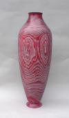 Tall hollow memosa vessel in red, white wax highlights.